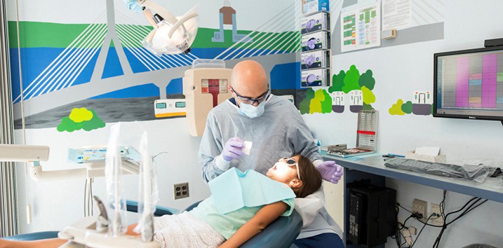 Pediatric dentist working on a child