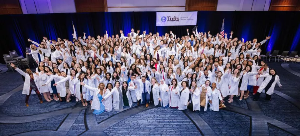 Students wearing their white coats in a group photo after the 2023 white coat ceremony