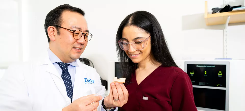 Doctor Damian Lee speaks to a student in the Digital Dentistry Lab