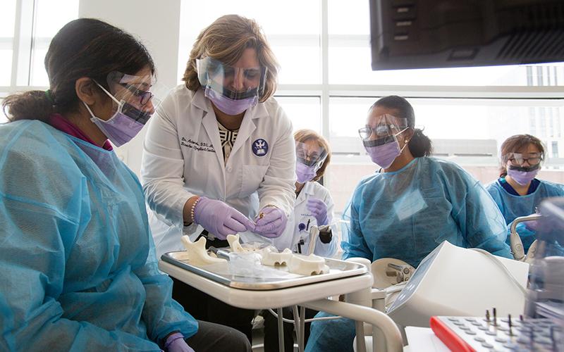 Dr. Ekaterini Antonellou demonstrates a technique during a hands-on course