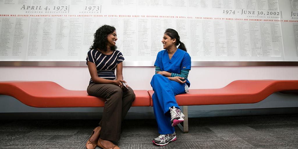 International students chatting while sitting on a bench