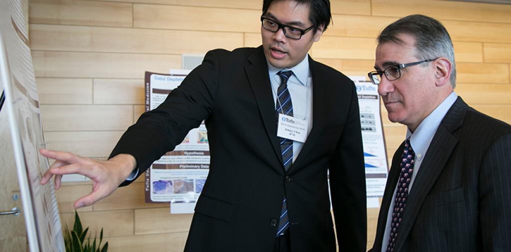 Tufts researcher explaining poster board