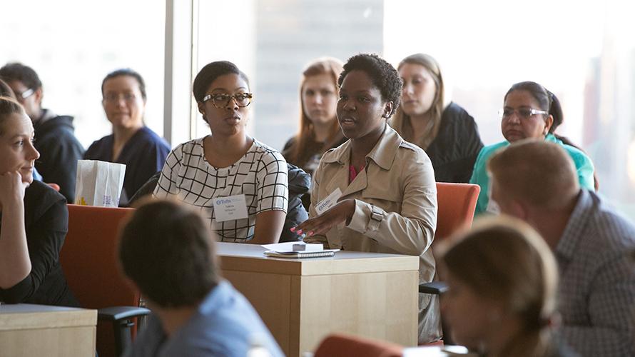 A student speaking in class while other students listen