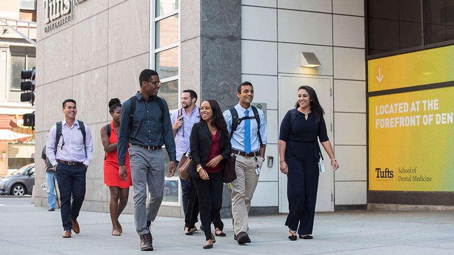 Students walking together down a sidewalk