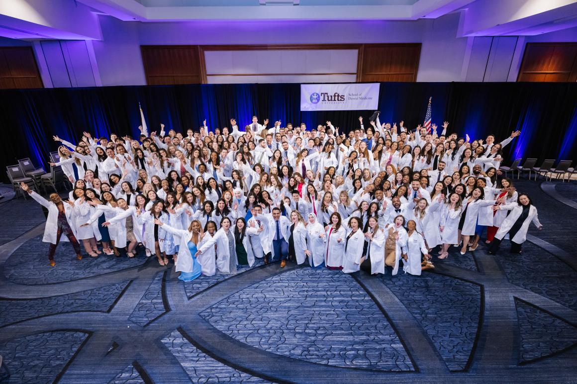 Group photo of graduating class in their white coats