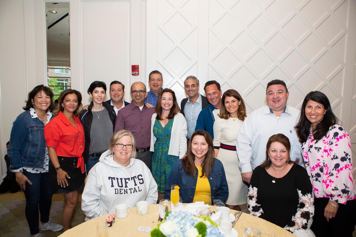 A group of Dental Alumni smiling for a photo at the 2019 alumni reunion