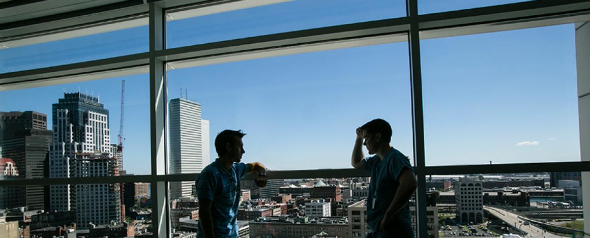 Students chatting in front of the skyline