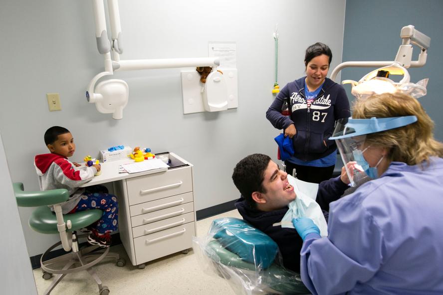 A dentist treating a young adult
