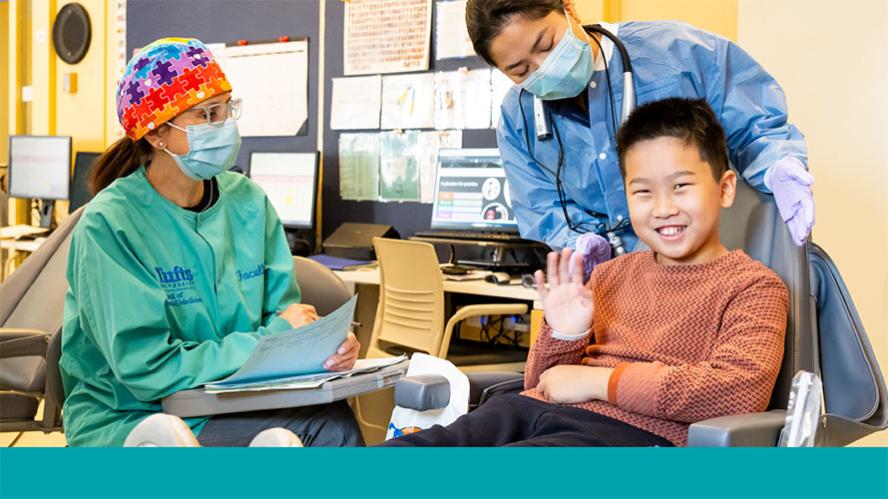Smiling child in dental chair at Josiah Quincy School