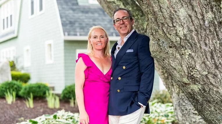 Anne Maka and Michael Dakin stand by tree