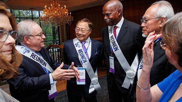 Group talking and wearing 50th Reunion sashes