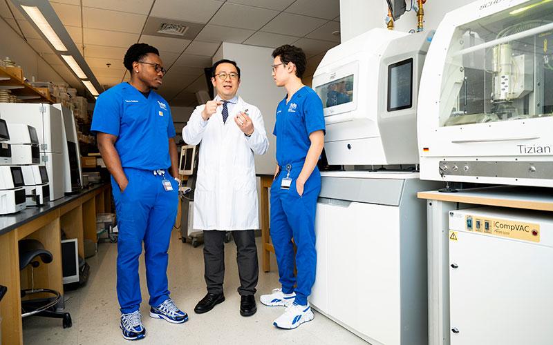 Students pose for photos in the Digital Dentistry Lab with Dr. Damian Lee, Chair of Prosthodontics at the Tufts University School of Dental Medicine