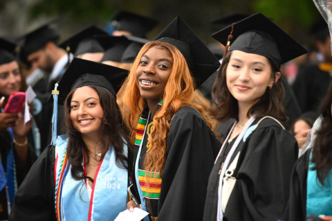 Three graduates at Tufts commencement ceremony