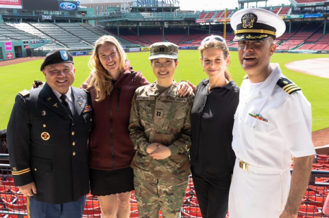 Five people in military uniforms uniform at Fenway Park.